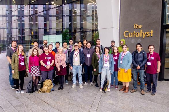 Most of the over 30 members of the Newcastle Unviersity RSE Team standing together outside the Catalyst building. Several of them are wearing RSECon24 t-shirts.