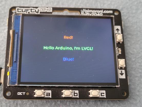 Photo of a Pimoroni Tufty2040 running the LVGL Arduino example code