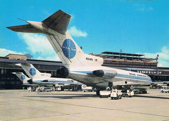 The view is of three tails of jetliners waiting outside the terminal. They are being loaded with bags.