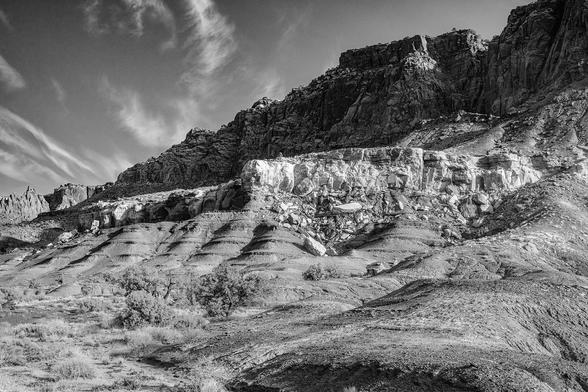 Rugged cliffs in Capitol Reef National Park rise dramatically to contrast with the sky’s delicate wispy clouds. The early morning light highlights the multiple layers of sedimentary rock that record nearly 200 million years of geologic history. Processed in black and white. 

capitolreef #nationalpark #blackandwhite #blackandwhitephotography #landscape #landscapephotography #geology #erosion #utah #rocky #BuyIntoArt #AYearForArt #artforsale #wallartforsale #giftideas @joancarroll 

https://joan-carroll.pixels.com/featured/capitol-reef-national-park-landscape-2-bw-joan-carroll.html