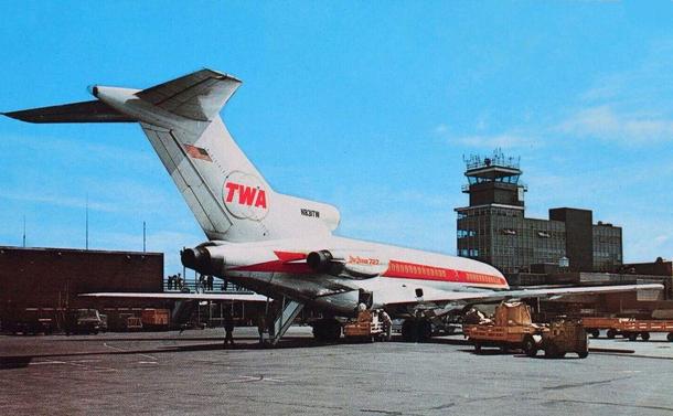 The view is up at the tail. In the background is the tower and main terminal building.