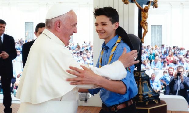 A photo of me leaving after having talked with the pope. He is laughing, I am smiling, and his right arm is holding my left arm.