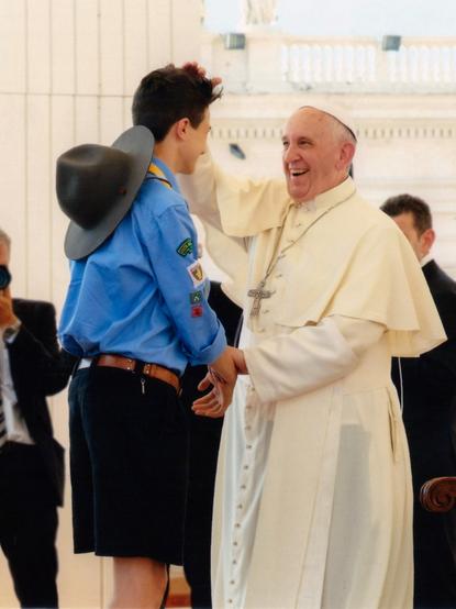 A photo from further of the pope patting me on the head