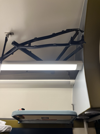 Bare bike frame on an overhead rack