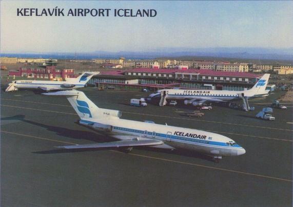 Two 727s and a DC-8 are seen at the Keflavik airport. The airport is in the background.