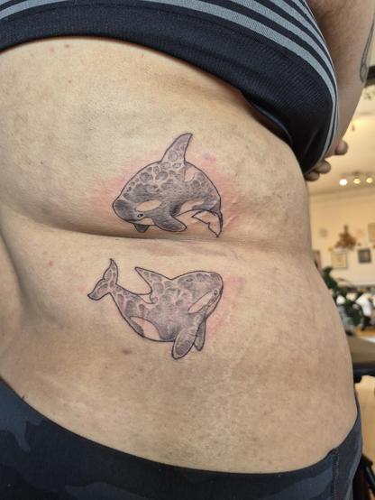 A photo of the same tattoos! you can see them around the birthmark a bit easier here.