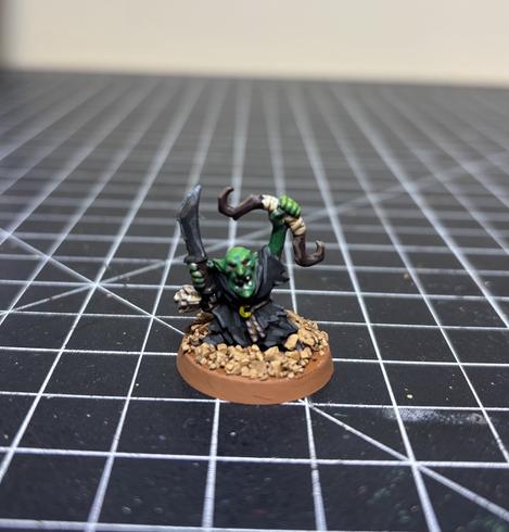 A miniature of a night goblin champion with bow from Warhammer