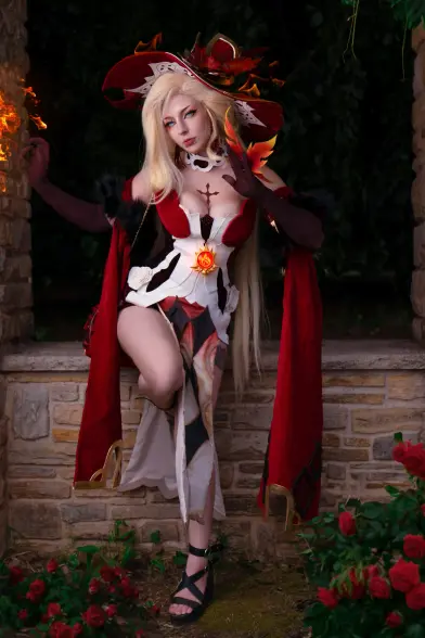 The image features a person dressed in a detailed cosplay outfit, standing in a garden-like setting. The costume is predominantly red and white, with a large, ornate hat adorned with flame-like decorations and feathers. The outfit includes a corset-like top with a prominent sun emblem in the center, a flowing red cape, and a skirt with a white and red pattern. The person is wearing black gloves and sandals, and has long, blonde hair. The background consists of a stone wall and lush greenery, with red roses visible at the bottom of the image. The person is striking a pose with one leg raised and hand on the wall, creating a dramatic effect.

Provided by @altbot@fuzzies.wtf, generated privately and locally using Ovis2-8B

🌱 Energy used: 0.185 Wh