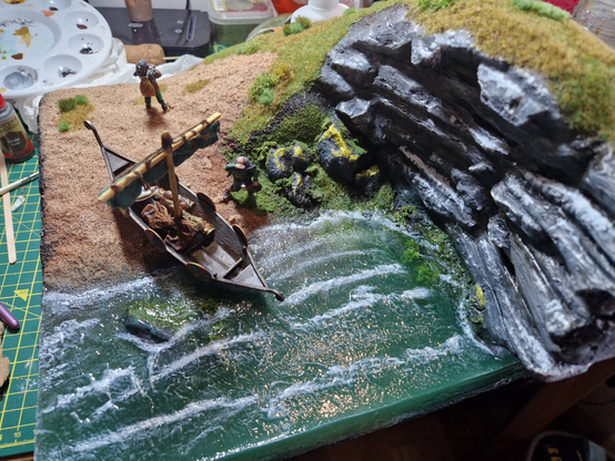 Gorgeous little diorama of a small drakkar being dragged onto a beach next to a large cliff, with some viking sailors scuting out the place.

There are no seagulls anywhere around.