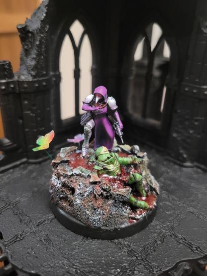 A purple and white Plague Doctor masked caped battle nun with a pistol, on top of a massive rock with a cadaver of an enemy on there. Lovely scene