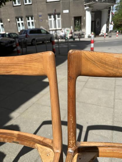 Closeup of two chairs, one in bad condition, the other much more pleasant and uniform looking. Wood grain is beautifully visible now.