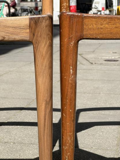 Closeup of chair legs, side by side. The old one was terribly scratched.