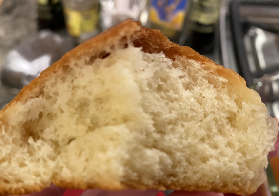 A side view of grain, showing large holes inside and a distinct but still soft crust layer