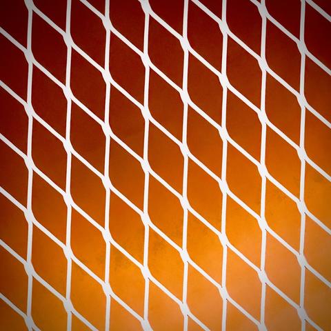 A gray, metallic, latticed gate overlays a red and orange backdrop.