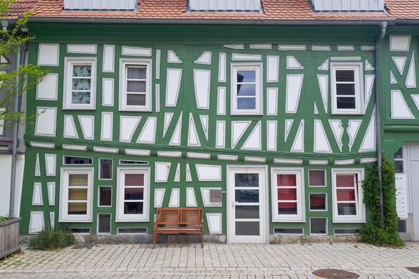 Ein Fachwerkhaus mit grünen Balken