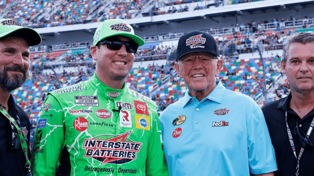 NASCAR Cup Series driver Kyle Busch (left center) and Joe Gibbs Racing owner Joe Gibbs (right center) in pit road prior to the start of the Coke Zero 400 at Daytona International Speedway.