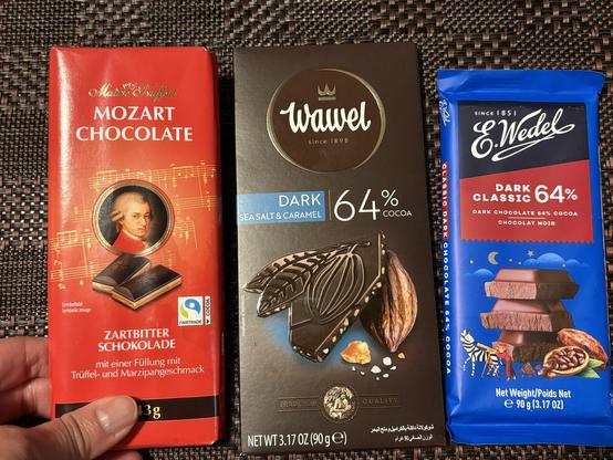Bar of Mozart Chocolate with some filling, A bar of Wawel 64% cocoa dark chocolate with sea salt and caramel and a bar of E. Wendell 64% cocoa dark chocolate