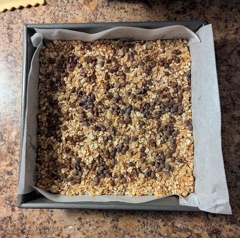 Image shows a pan of chocolate chip granola bars.