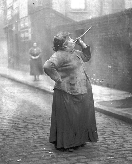 Mary Smith, a “knocker-upper” who earned sixpence a week shooting dried peas at windows to wake people for work (East London, 1930s)