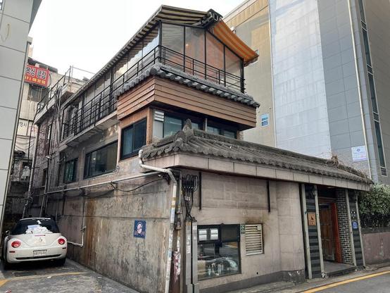A three-story building with a traditional Korean roof.