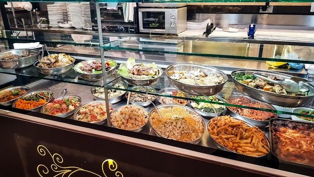 A display case filled with various prepared foods.