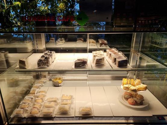 A bakery display case filled with cakes and pastries.