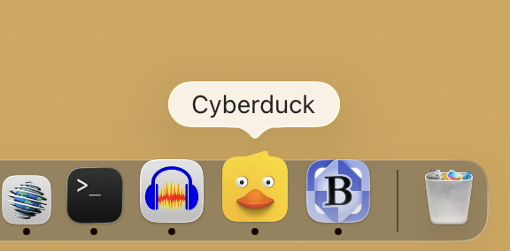 Cropped screenshot of the Dock on Mac OS Tahoe, showing a few icons. Cyberduck, the FTP client, has the face of a duck with a feather that pokes out of the rounded rectangle.