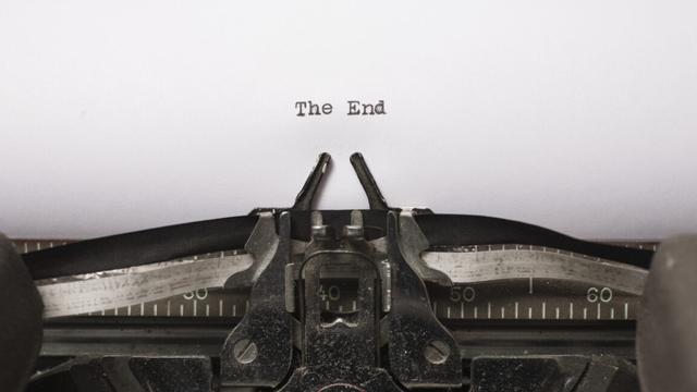 Photo of a typewriter that has typed out "The End" on a piece of paper.