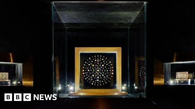 The photo shows jewels linked to the Buddha's remains displayed behind a glass casing. These are considered among the most extraordinary archaeological finds of all time