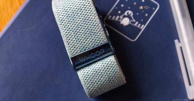 The Whoop 4.0 on top of a notebook