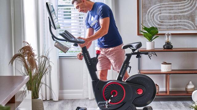 Someone adjusting their Echelon Connect EX-5s-22 bike.