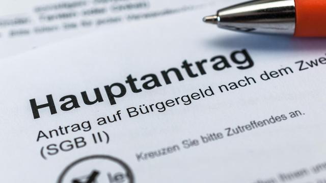 Auf dem Formular liegt ein roter Kugelschreiber.