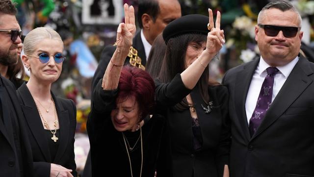 Kelly and Sharon Osbourne mourn with fans at the funeral of Black Sabbath frontman Ozzy Osbourne.
