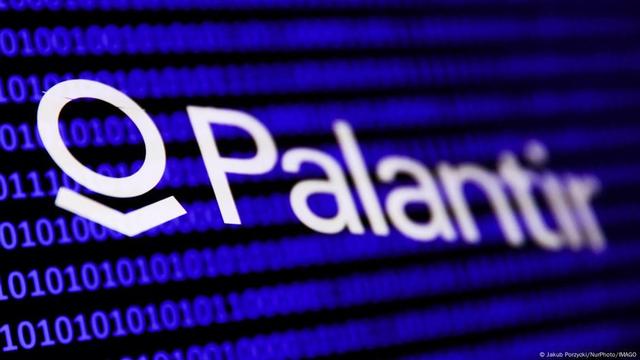 Palantir Logo against a blue binary code backdrop