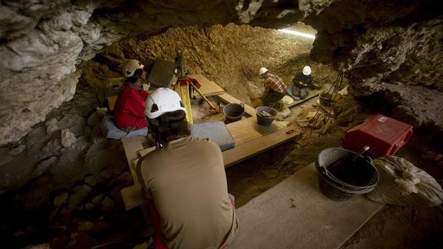 Archaeologists working in a cave.