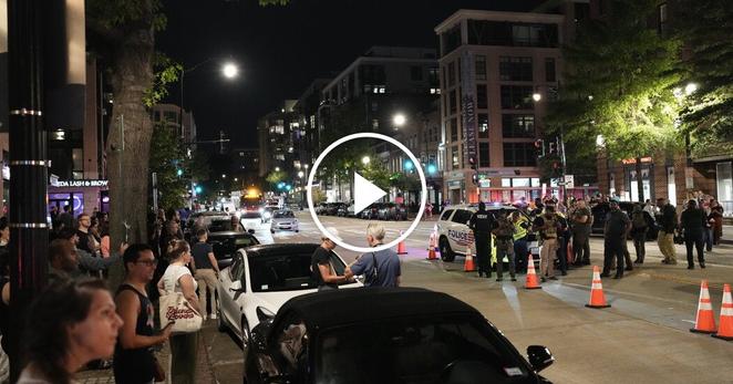 People gathered to watch federal agents and police in Washington on Wednesday evening.