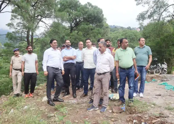 Deputy Commissioner of Kangra, Hemraj Bairwa with his team inspecting the landslide site near Dharamshala.