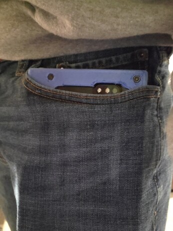 Folding dual pinephone case crammed uncomfortably in a pants pocket