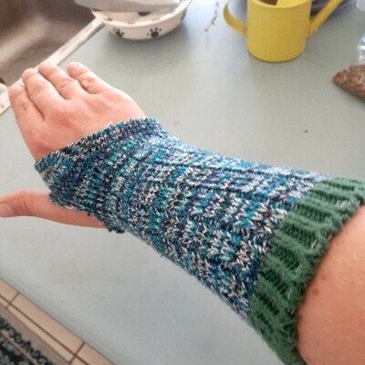 Sock with holes worn as a glove.