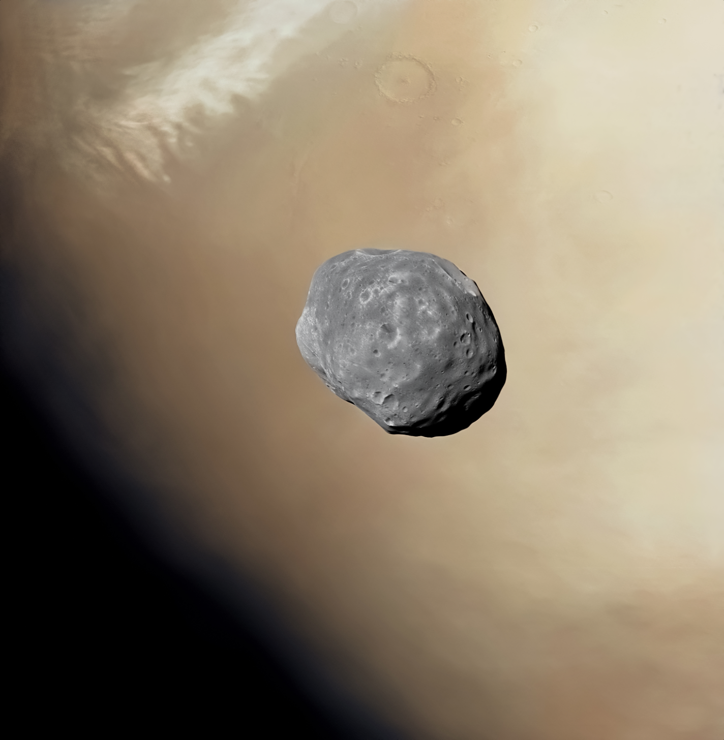 In this image we can see the tiny potato shape satellite of Mars - Phobos - orbiting nearby the Terminator. THe nice and cloudy atmosphere of Mars and some craters are also visible on the surface. Typical rusty colour of Mars and greyish of Phobos.