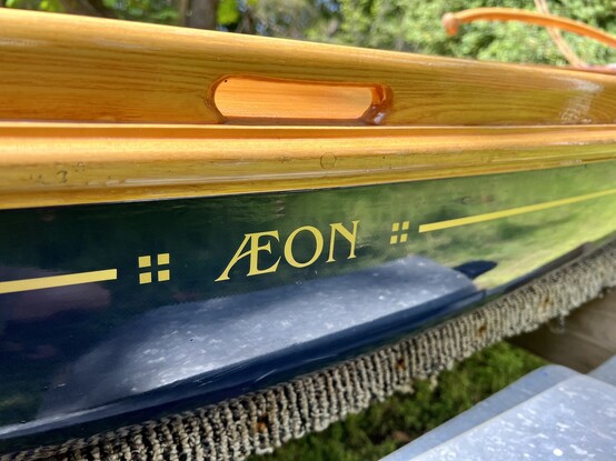 Close-up of the name of the boat in gold a long haul. The name is Aeon. 