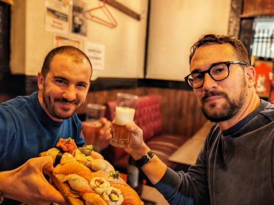 Friends cheering with food and beers
