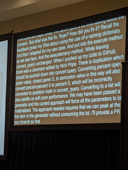 A picture of the live captioning, including "Converting percent open paren value, closed paren S, to semicolon value in this way will also convert percent-percent S to percent S, which will be incorrectly converted to question mark in convert_query"