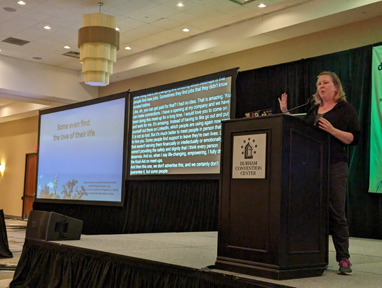 Deb talking at the podium with a slide titled "Some even meet the love of their life"