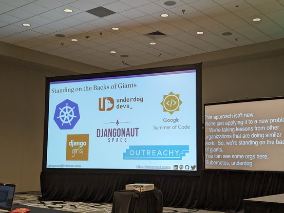 Slide titled "standing on the backs of giants" with logos from kubernetes, Google summer of coffee, Django Girls, outreachy, and underdog devs