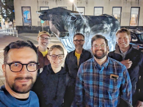 People in front of the statue of a bull, symbol of the city of Durham