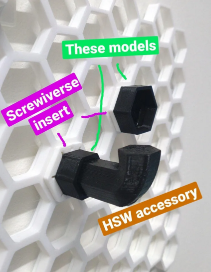 photo of white honeycomb storage wall with two screwiverse snap-in inserts, each with a new black adapter screwed in, enabling to insert common honeycomb storage wall accessories into them. In the smaller one, an original HSW hook is inserted. 