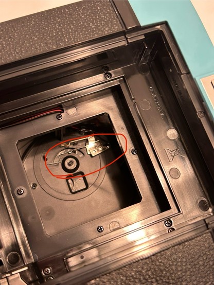 Inside the film door of the Diana instant square. Circled in red is a contact that’s just dangling by a wire.