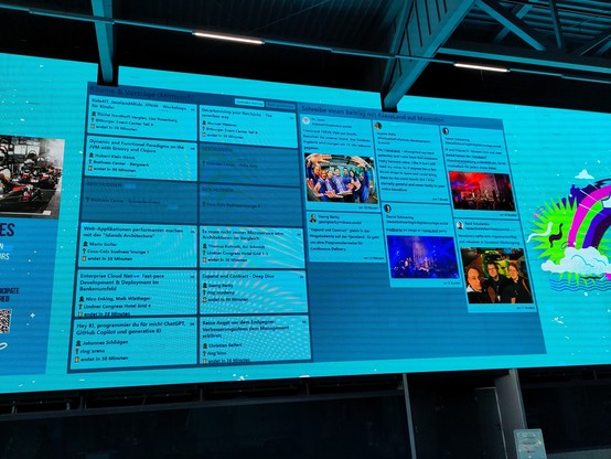 A photo of the Mastodon wall at the Javaland conference showing the agenda on the left and Mastodon posts on the right.