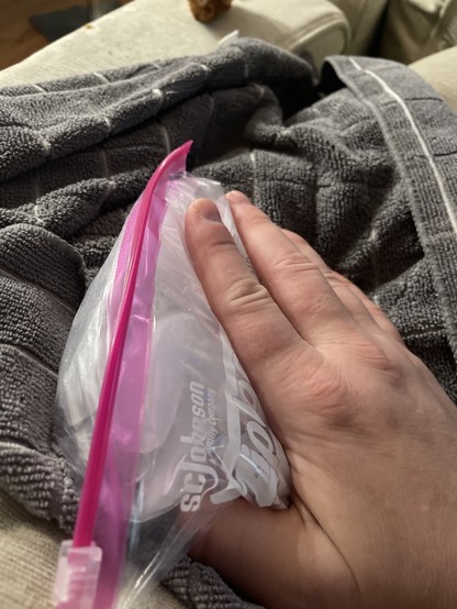 My hand wrapping a bag of ice.